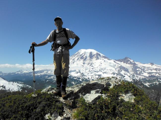 Rick summits Stevens - Rainier in background