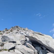 View of Vesper Peak showing the approach and people enjoying the view
