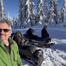 Josh and DJ with the snowmobiles getting ready for the hike