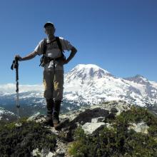 Rick summits Stevens - Rainier in background
