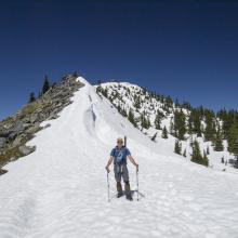 K7MAS - Wallowing in soft spring snow on Granite Mountain.  Summit Lookout Tower behind. Photo: KG7EJT