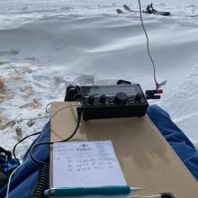 A KX2 with a wire antenna sitting on a clipboard on my lap
