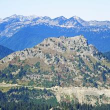 SOTA Deadwood Pk seen from the summit.  The PCT and Hiway 410 can be seen at its base.  The background peaks are the Sourdough Ridge near the Sunrise Area in Mt Rainier Nat Park.