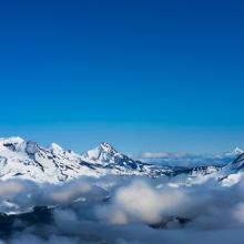 South Sister, Middle Sister, North Sister, and Broken Top Mountains in blue ski