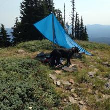 SOTA pole and its guy lines hold up the tarp on the summit